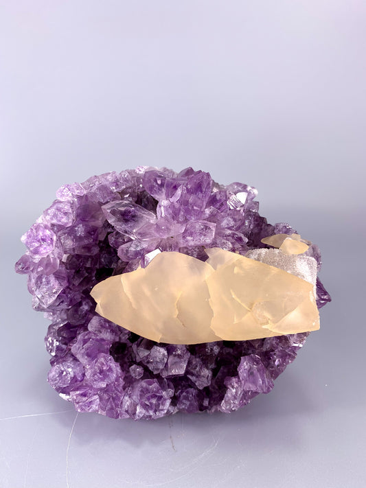 Amethyst natural cut base cluster with fish shaped calcite