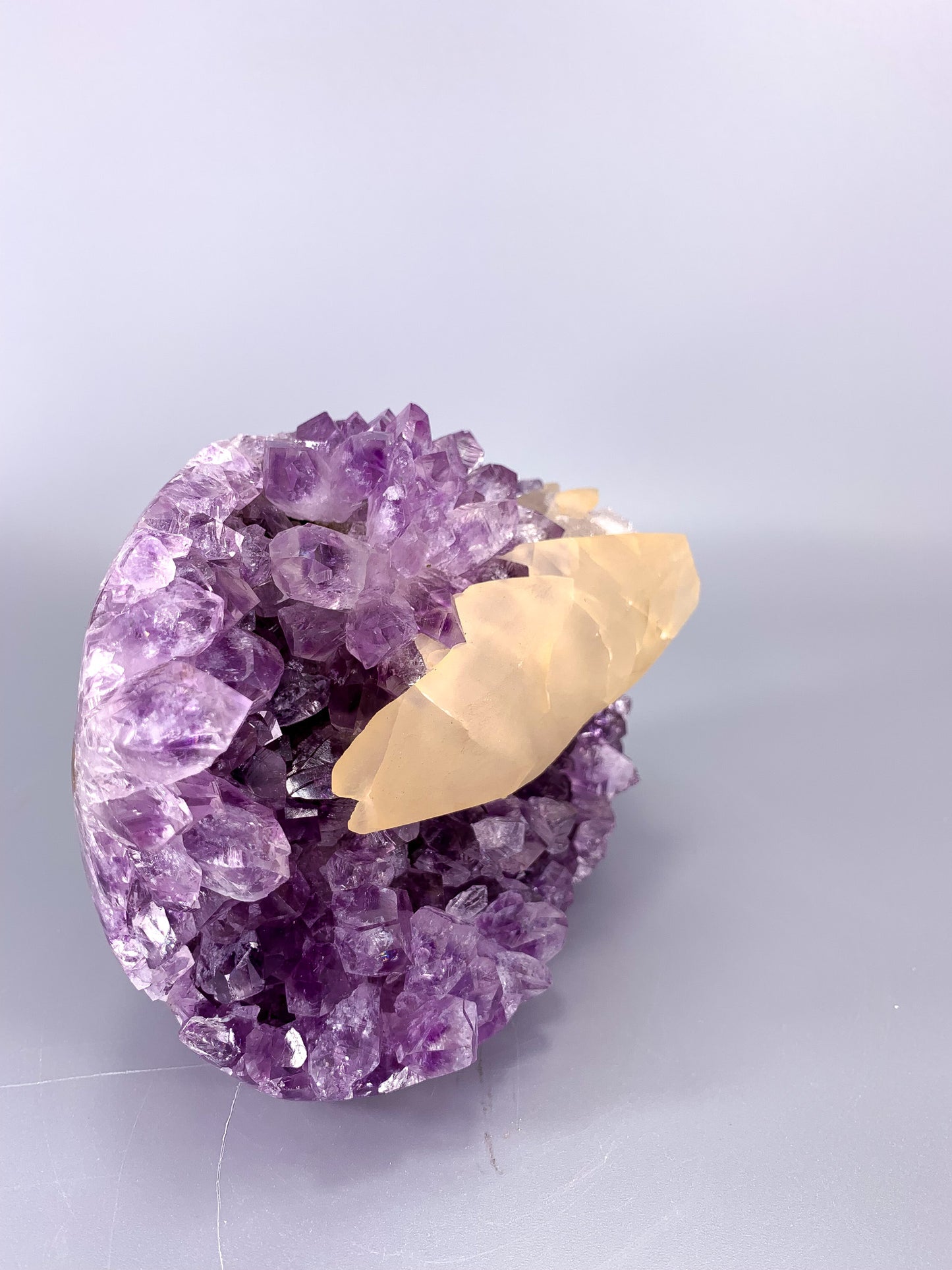 Amethyst natural cut base cluster with fish shaped calcite