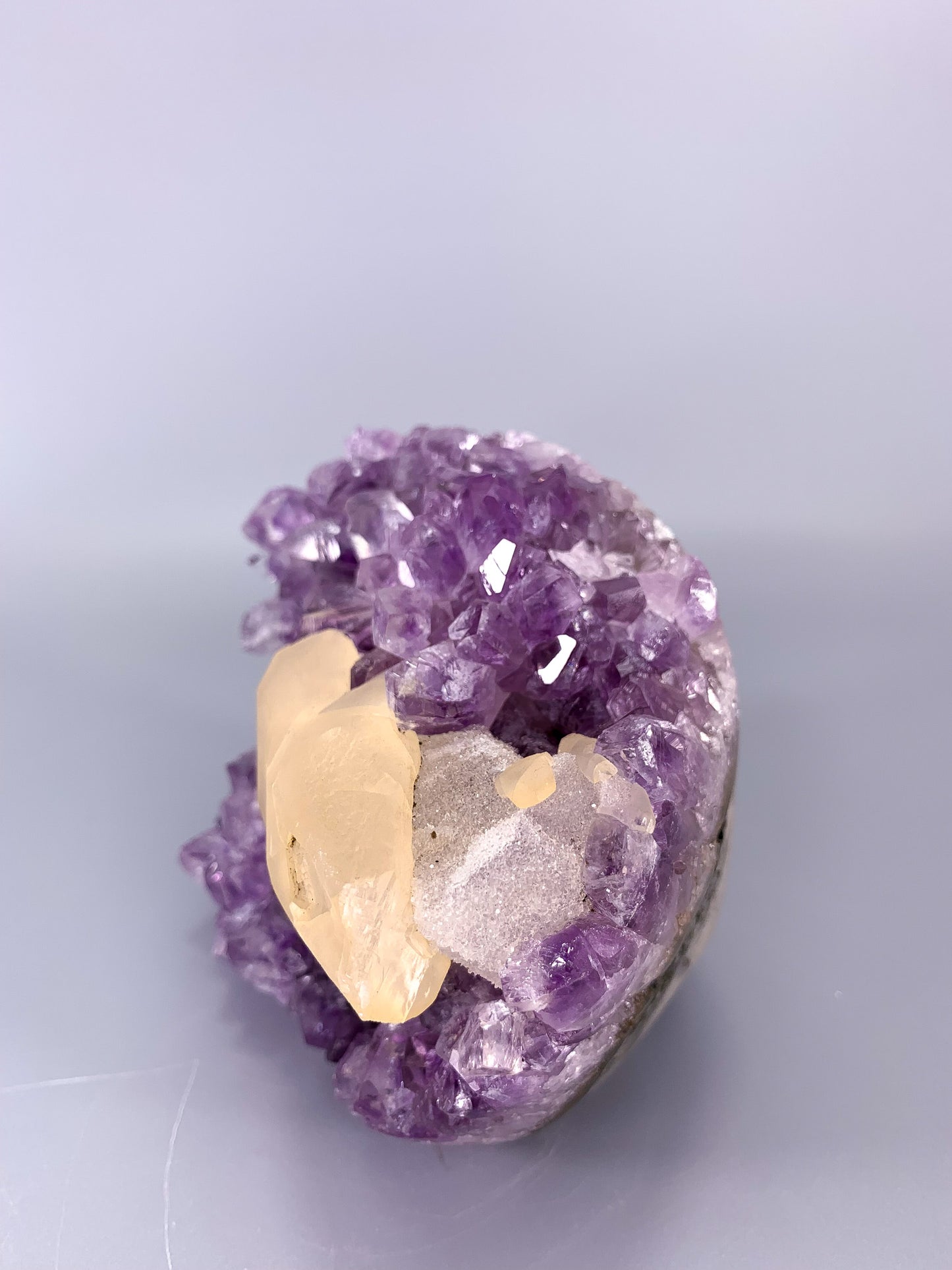 Amethyst natural cut base cluster with fish shaped calcite