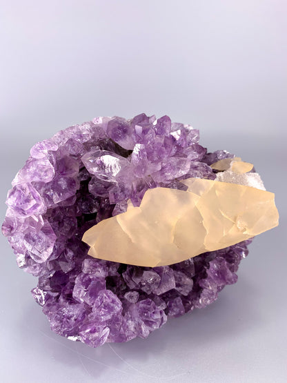 Amethyst natural cut base cluster with fish shaped calcite