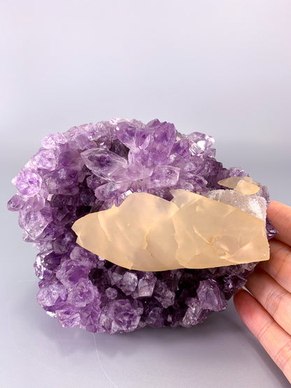 Amethyst natural cut base cluster with fish shaped calcite