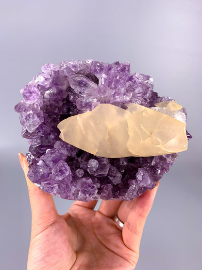 Amethyst natural cut base cluster with fish shaped calcite