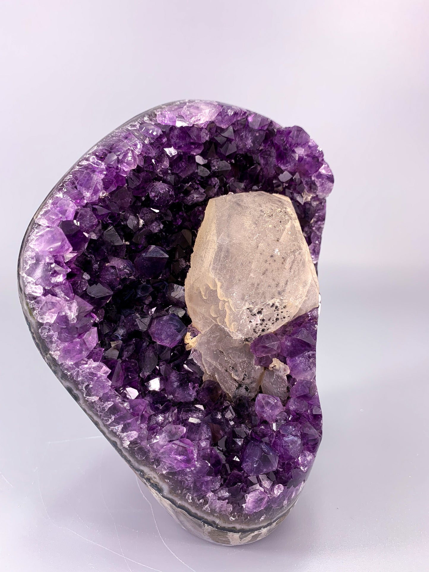 Amethyst natural cut base cluster with calcite