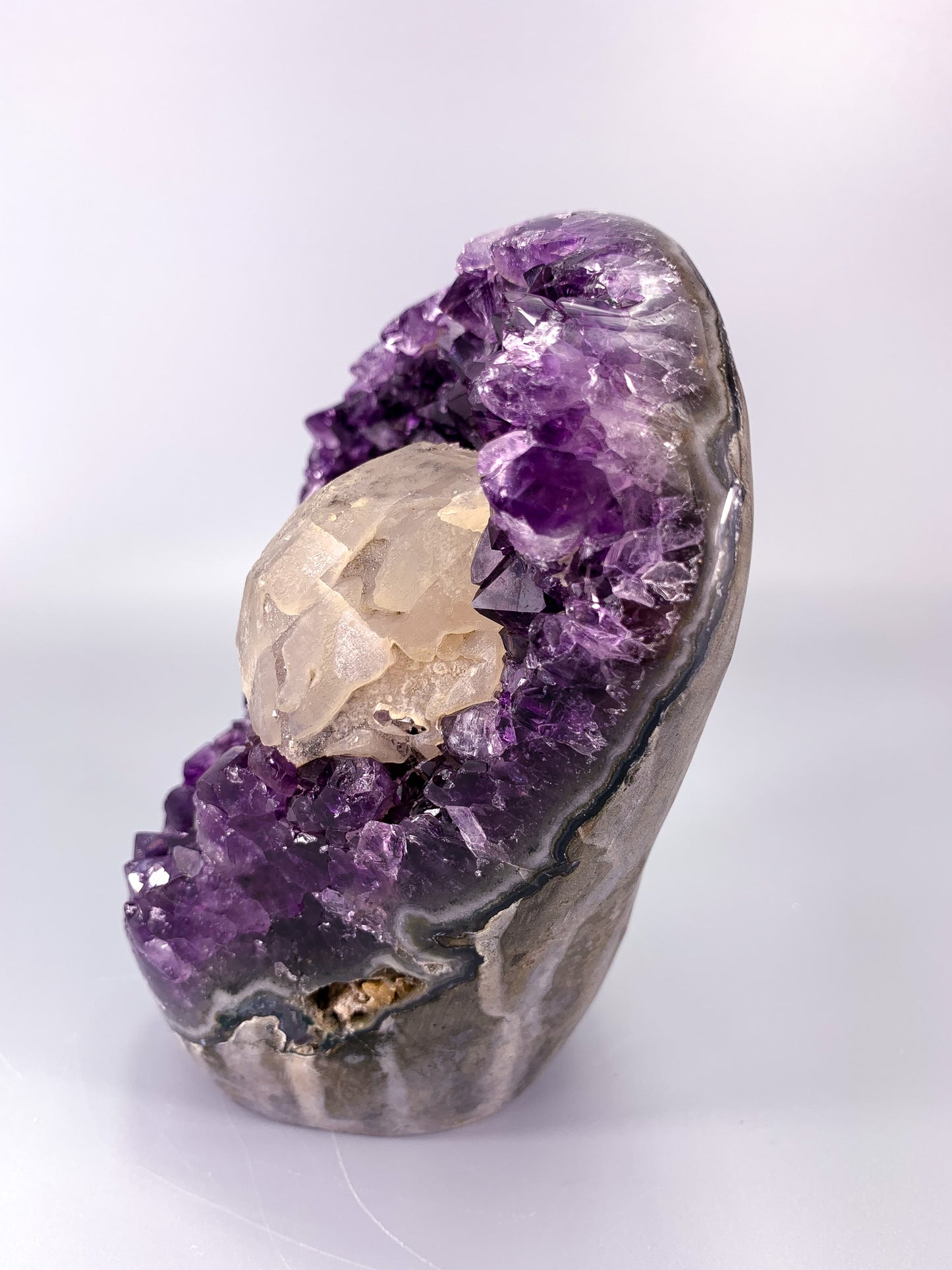 Amethyst natural cut base cluster with calcite