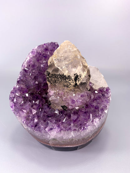 Amethyst natural cluster cut base with clear calcite point and Hematite