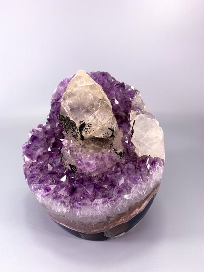 Amethyst natural cluster cut base with clear calcite point and Hematite