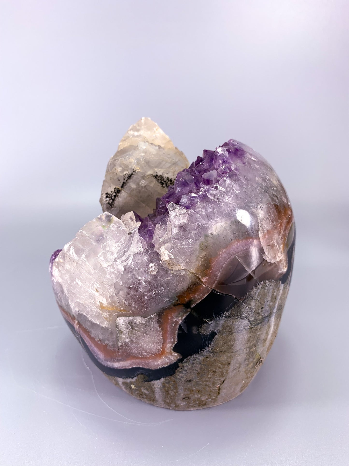 Amethyst natural cluster cut base with clear calcite point and Hematite