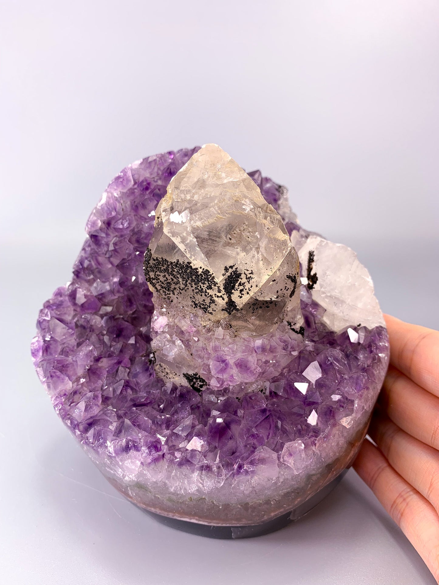 Amethyst natural cluster cut base with clear calcite point and Hematite