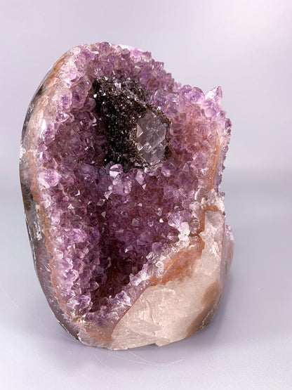 Amethyst natural cluster cut base with clear calcite and Hematite