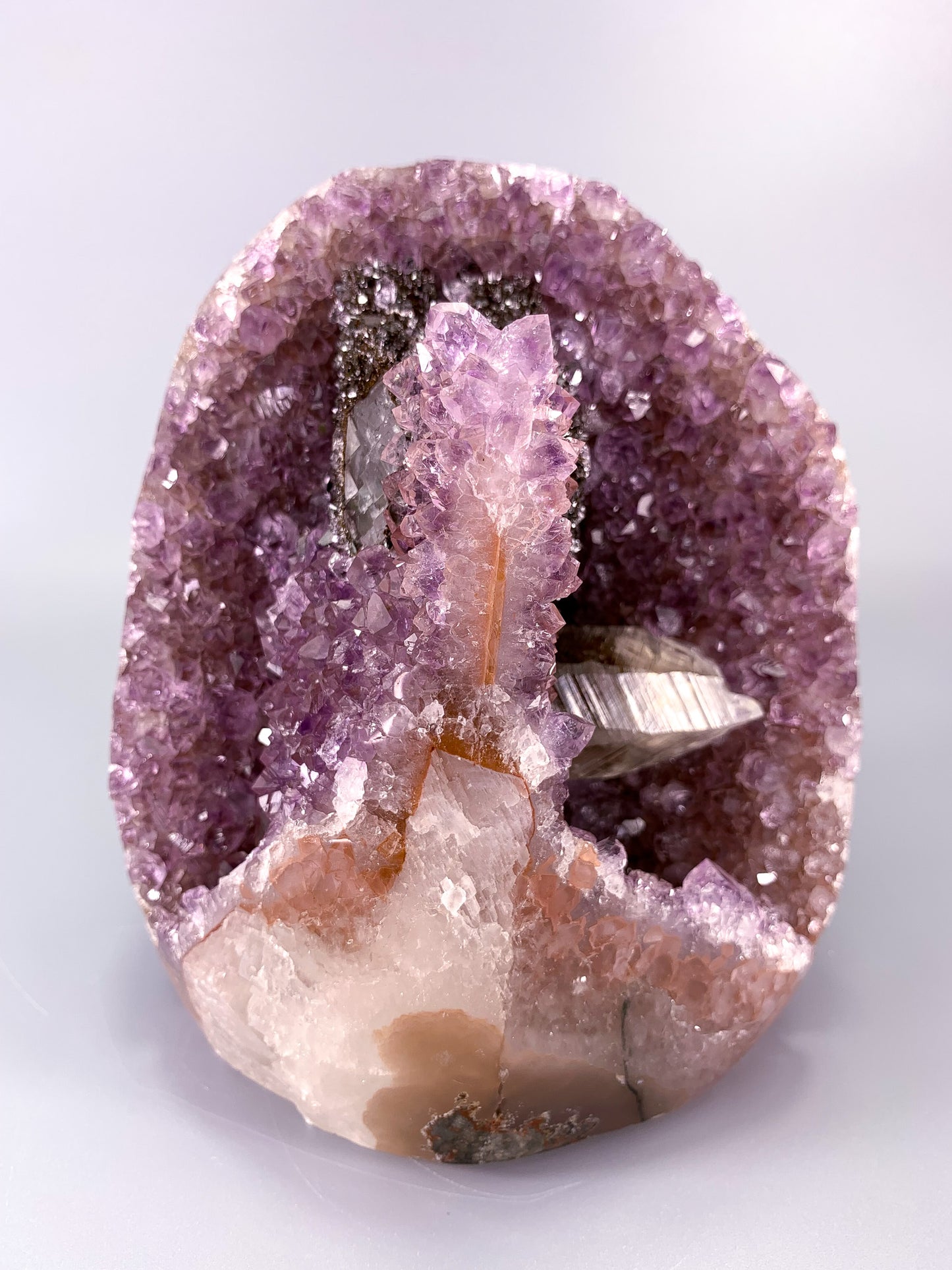 Amethyst natural cluster cut base with clear calcite and Hematite