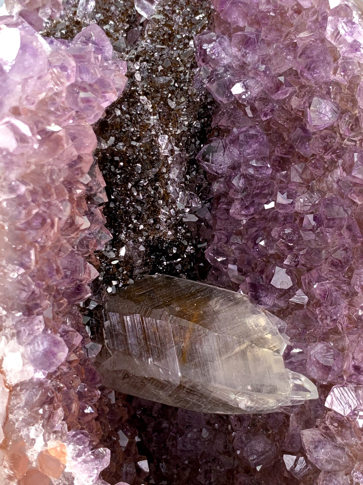 Amethyst natural cluster cut base with clear calcite and Hematite