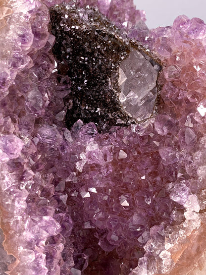 Amethyst natural cluster cut base with clear calcite and Hematite